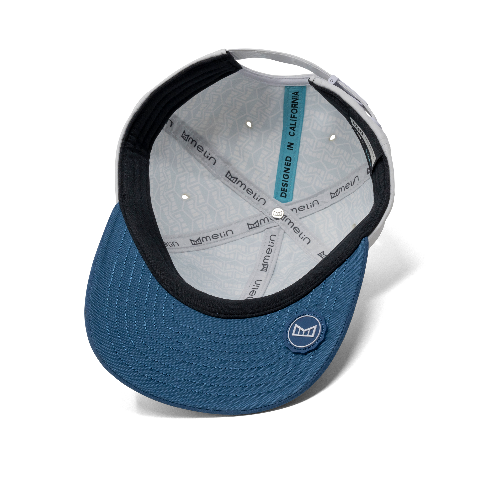 The inside view of the melin The Legend Hydro  Performance Dad Hat in  Steel Blue / White